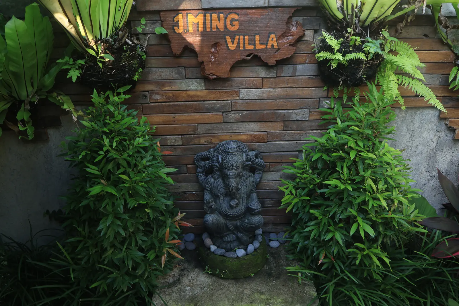 J Ming Villa entrance sign and tropical planting